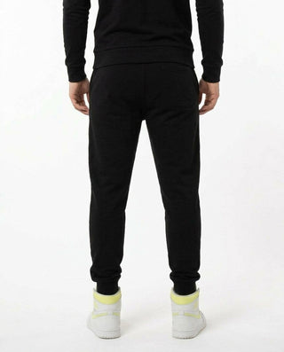 Back view of man wearing black AbXcore joggers with plain black back, on a white background