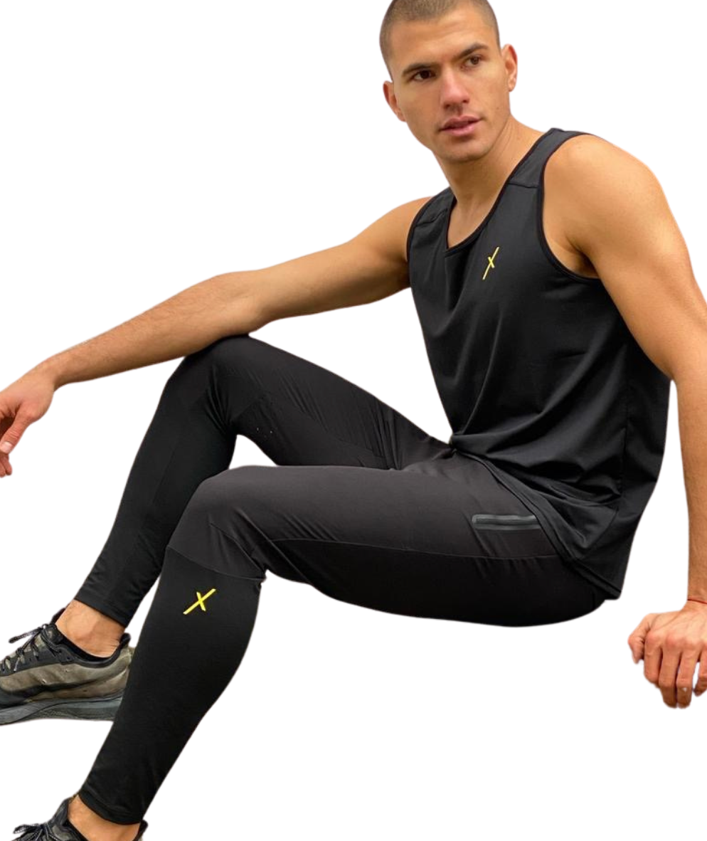 Man wearing a black athletic outfit with yellow text